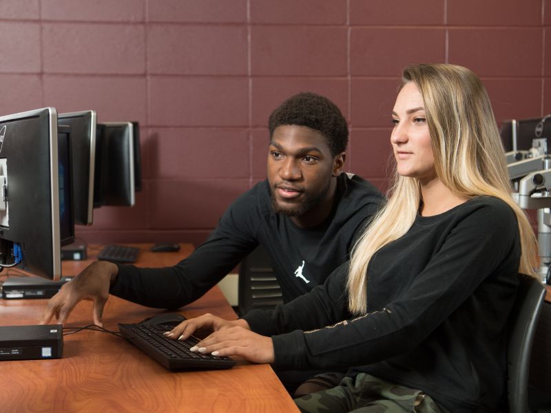 students looking at computer