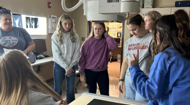 Class of rad tech students standing in lab.
